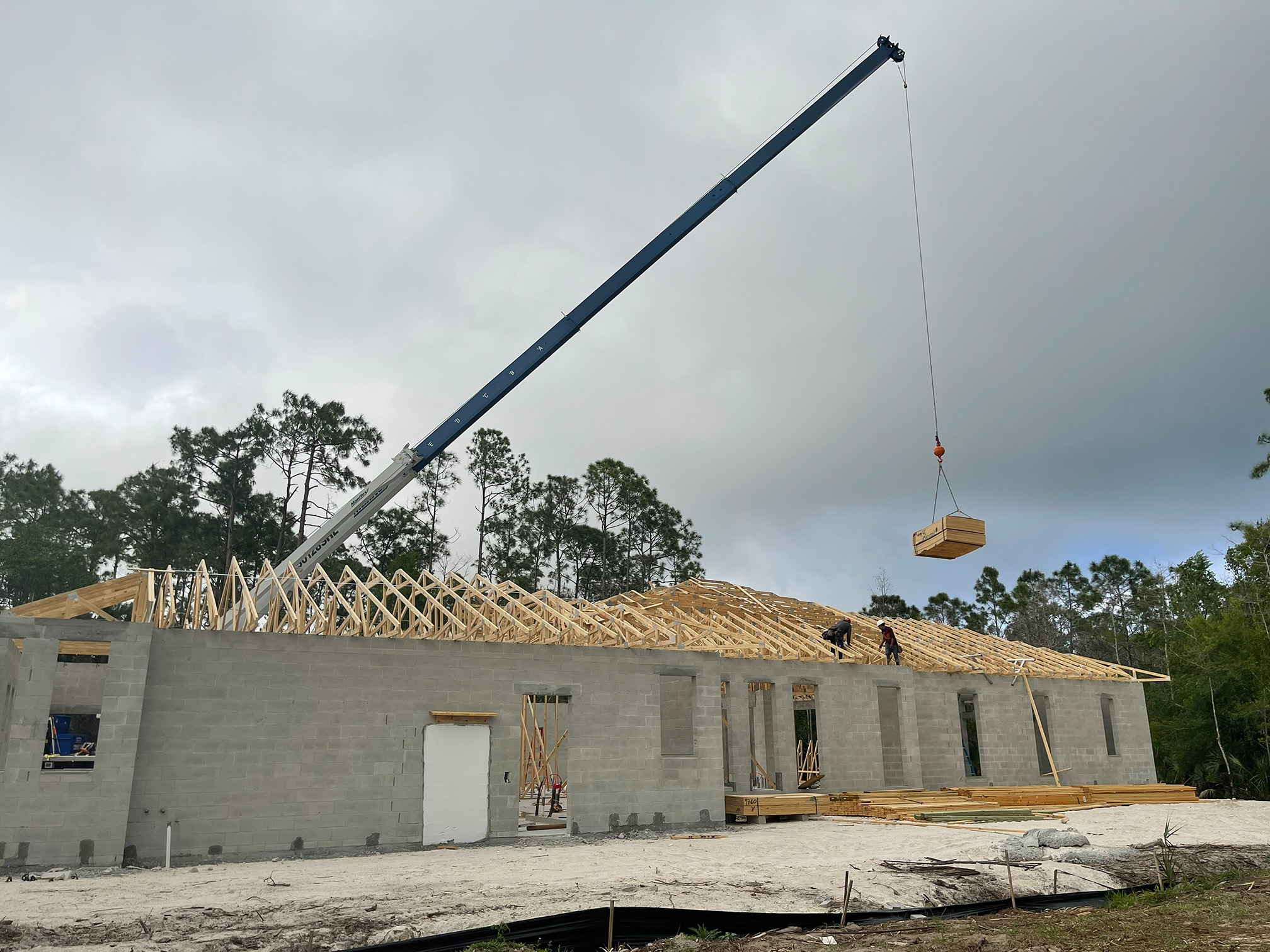 Trusses being set by crane on single-story home in Bonita Springs
